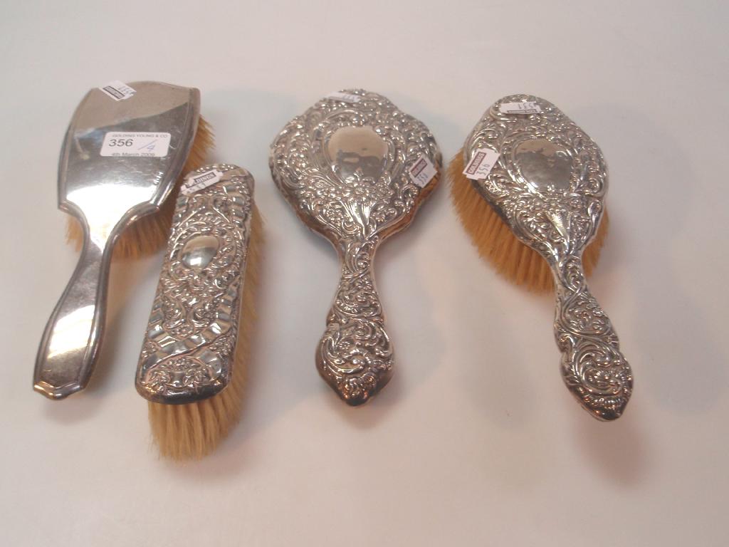 Appraisal: A silver backed hand mirror and matching hairbrush a similar