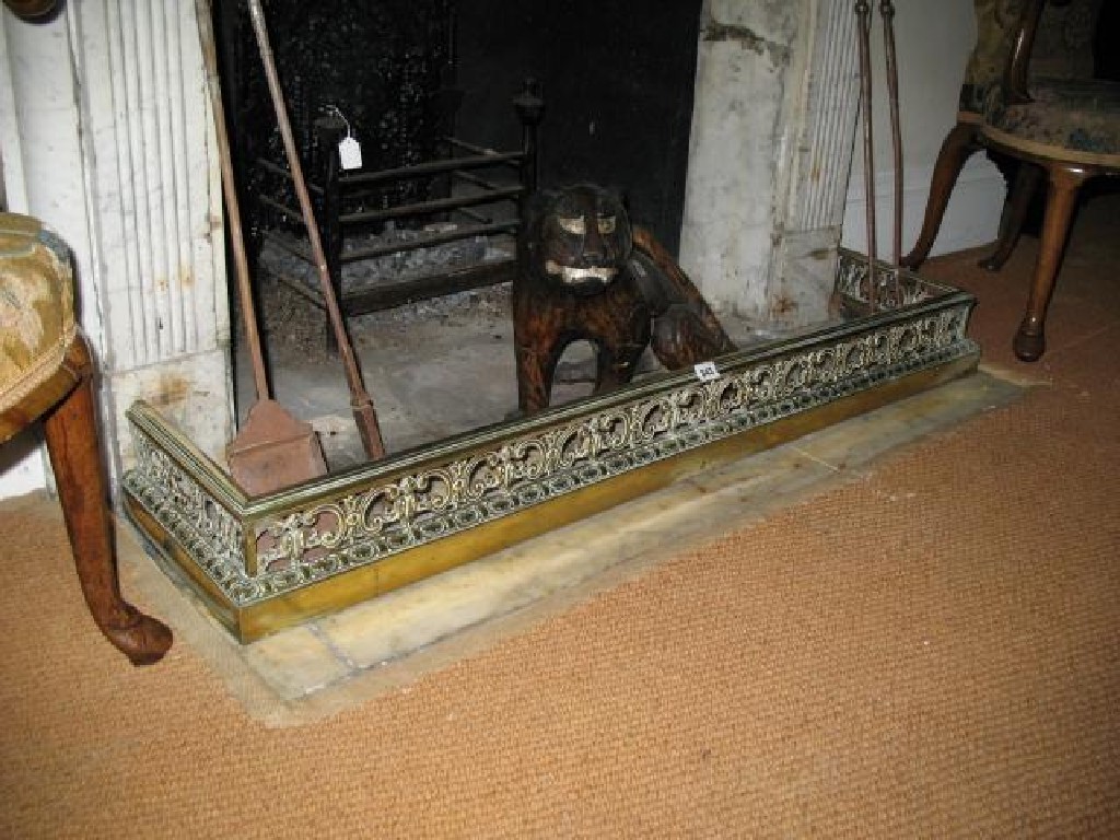 Appraisal: A REGENCY BRASS FIRE CURB pierced and cast with C