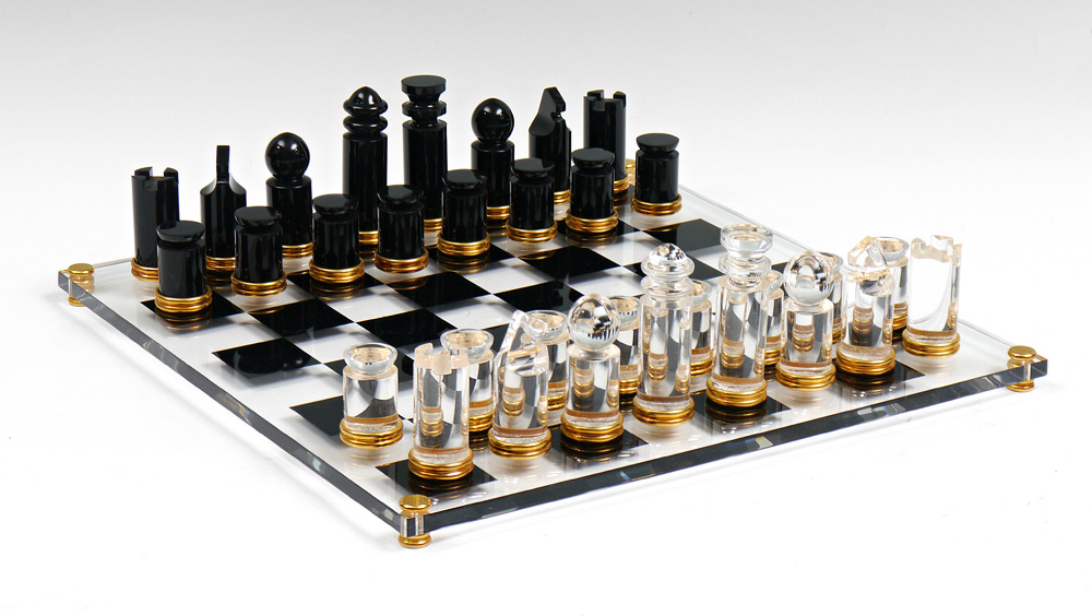 Appraisal: MODERNIST LUCITE CHESS SET Black and clear pieces with gold