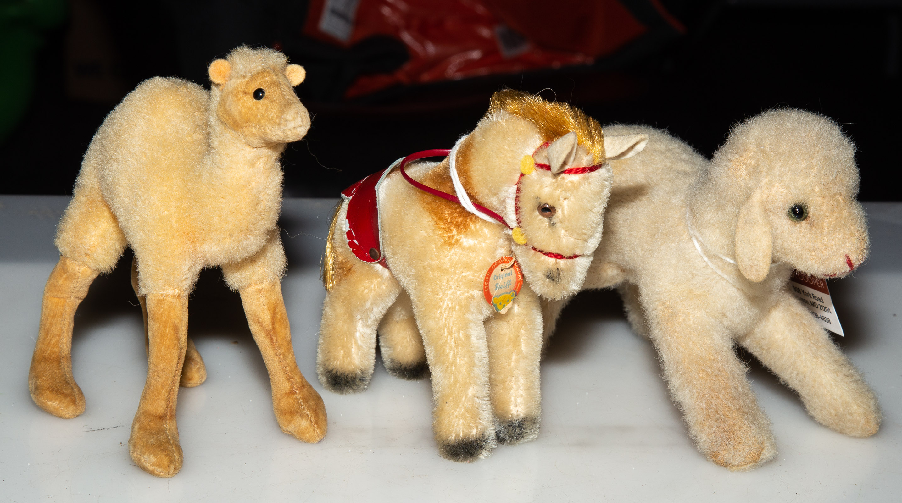 Appraisal: THREE STEIFF PLUSH ANIMALS Includes a lamb camel and a