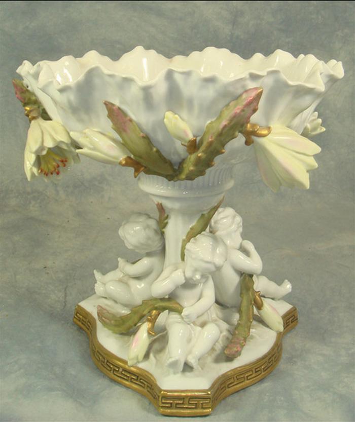 Appraisal: Porcelain shell form compote with cherub supported base unmarked numbered