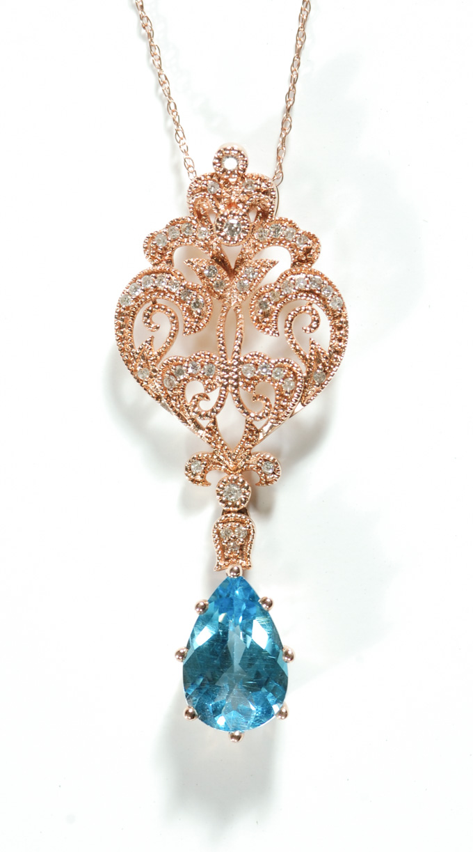 Appraisal: BLUE TOPAZ AND DIAMOND PENDANT NECKLACE suspended on an inch