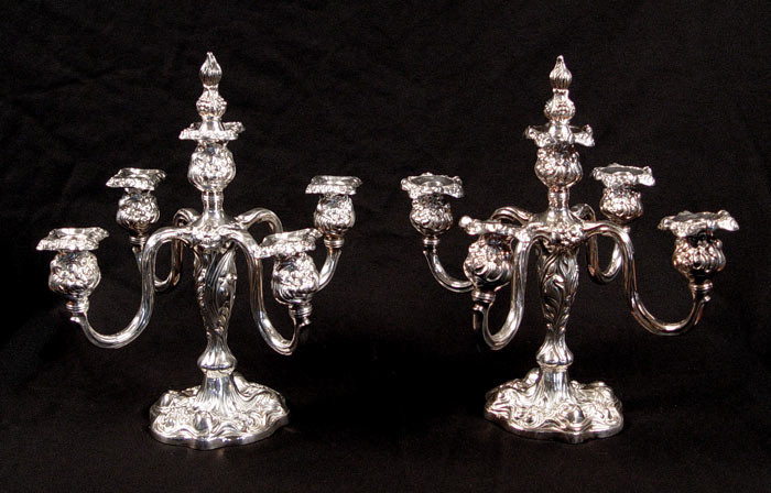 Appraisal: PAIR LIGHT APOLLO SILVERPLATE CANDELABRA Repousse floral and garland design