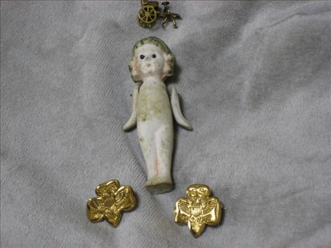 Appraisal: DOLL WITH CHARM AND TWO BROOCHES Small lovely porcelain doll