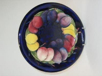 Appraisal: A MOORCROFT POTTERY PLATE tube lined in the Wisteria design