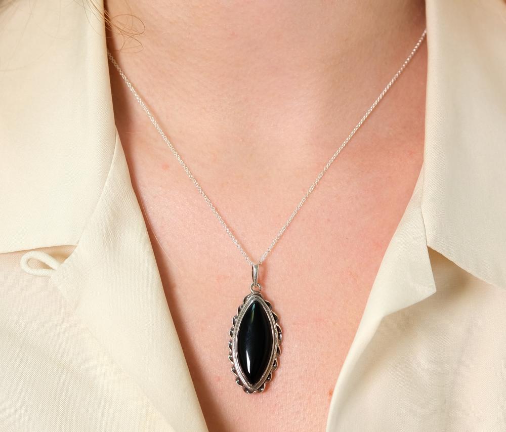 Appraisal: Sterling silver necklace hung with a marquise shaped black Onyx