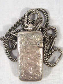 Appraisal: A silver long guard chain with a small silver vesta