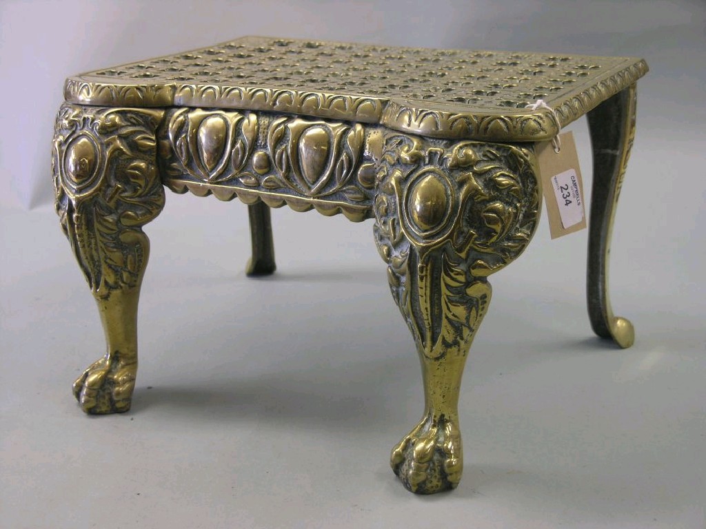 Appraisal: A brass footman pierced top above front cabriole legs with