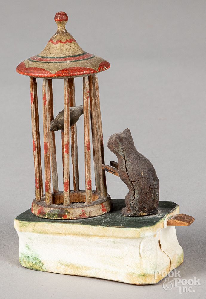 Appraisal: Cat and bird in cage pipsqueak toy th c Cat