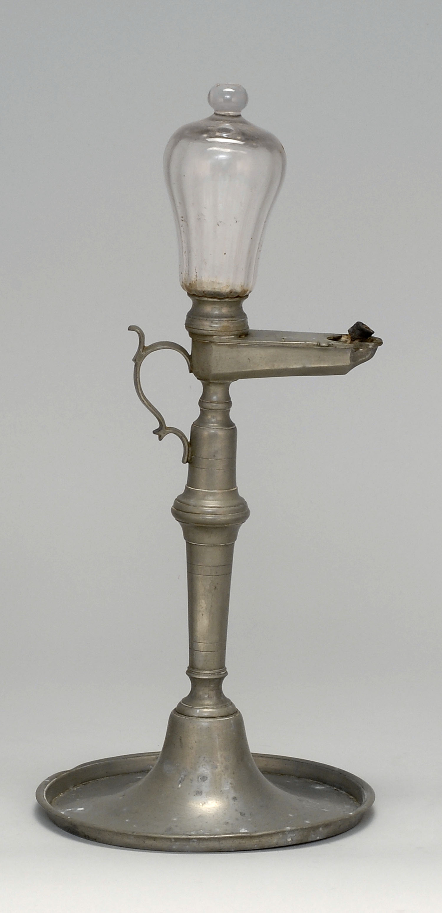 Appraisal: TH CENTURY SPUN PEWTER TIME LAMP with clear glass free-blown