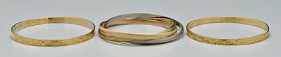 Appraisal: Three gold bangle bracelets pair kt yellow gold tested embossed