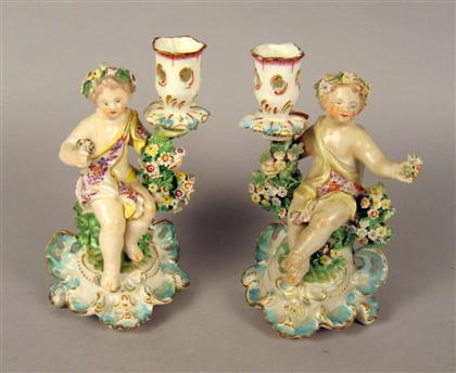 Appraisal: Three Chelsea style porcelain figural candlesticks th century Comprising a