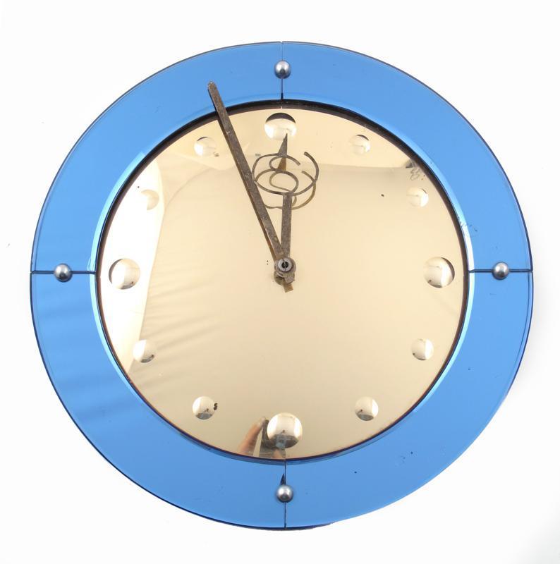 Appraisal: A Smiths mirrored glass electric wall clock