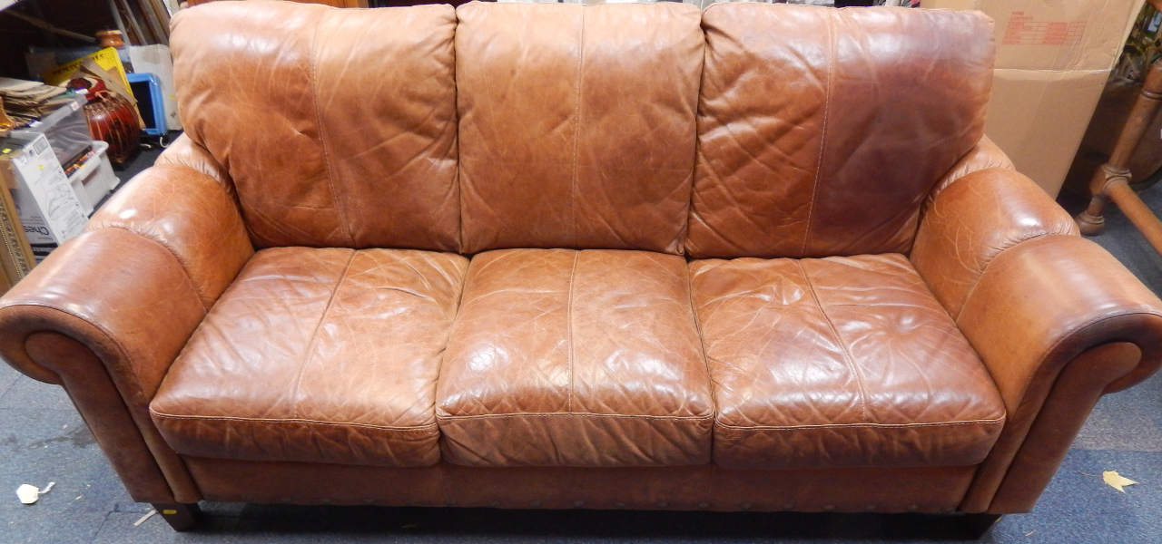 Appraisal: A tan leather three seater sofa cm long