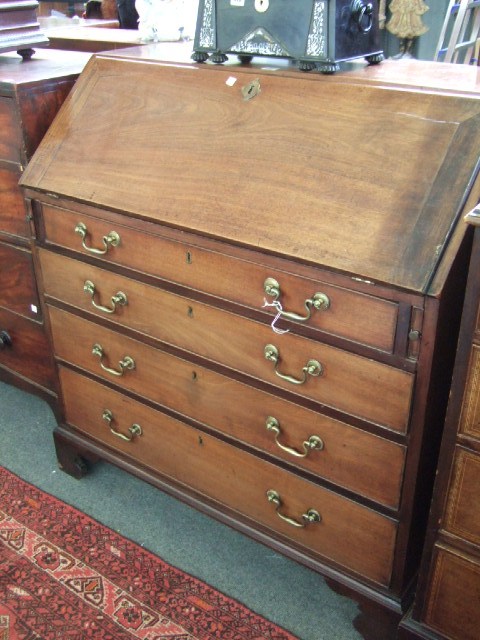 Appraisal: A George III mahogany bureau the fall enclosing a fitted