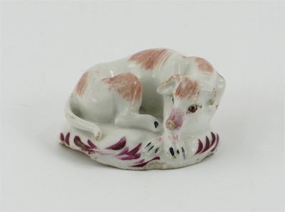 Appraisal: A small Bow figure of a recumbent hound his chin