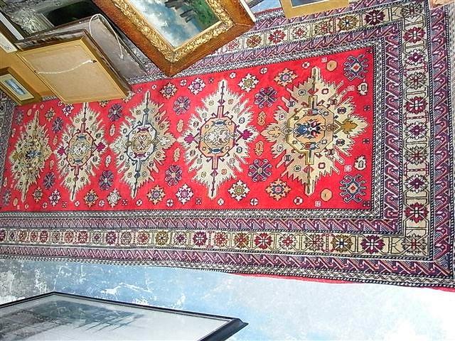 Appraisal: A RED GROUND TURKISH RUG with five central medallions and