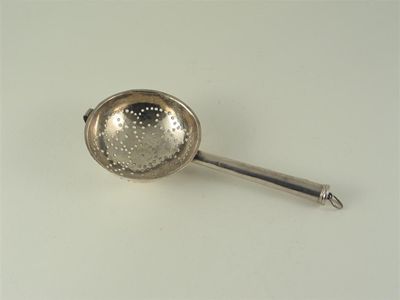 Appraisal: An early th century lemon strainer with a tapering tubular