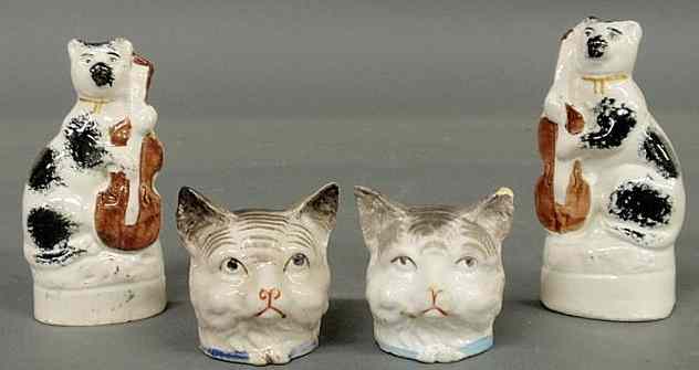 Appraisal: Pair of th c Staffordshire cats with string instruments h