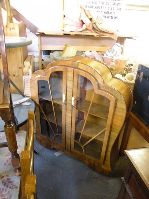 Appraisal: An Art Deco walnut display cabinet of shaped form the