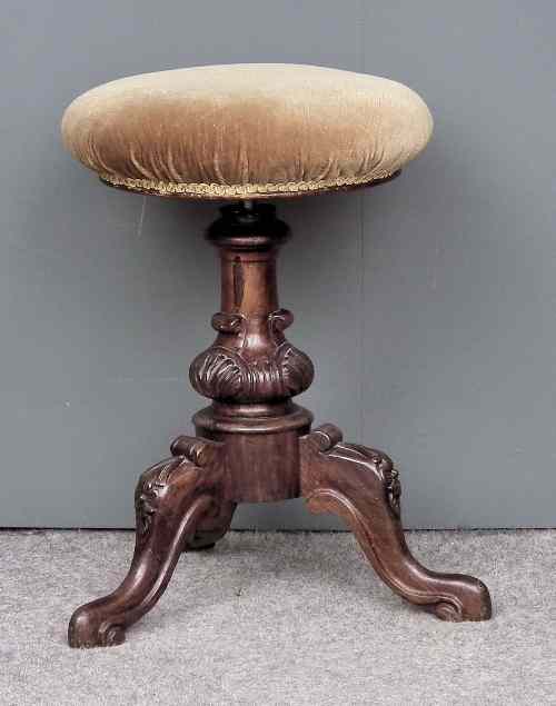 Appraisal: A Victorian rosewood circular piano stool the circular adjustable seat