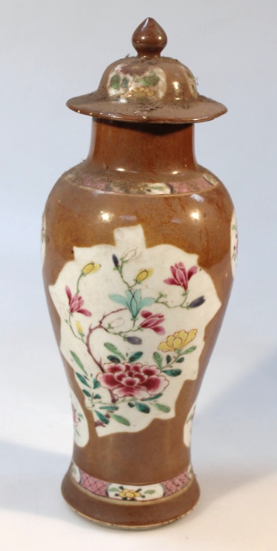 Appraisal: A porcelain vase with domed overhanging lid the shouldered body