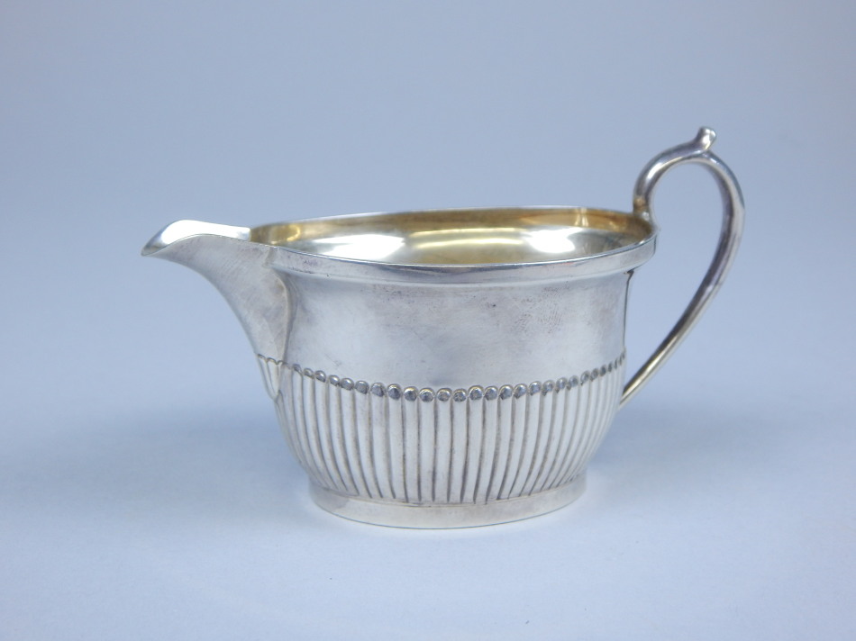 Appraisal: An Elizabeth II small silver part fluted cream jug Sheffield