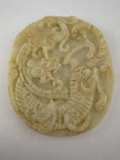 Appraisal: A Chinese oval jade pendant carved in bas relief with