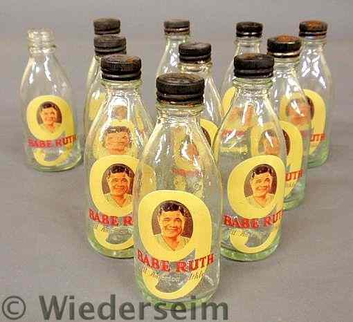 Appraisal: Rare group of eleven glass bottles decorated with Babe Ruth-