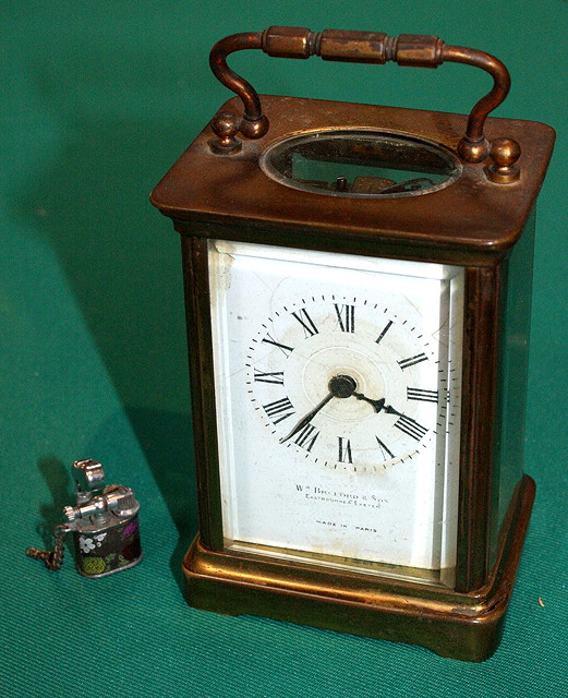 Appraisal: A BRASS CARRIAGE CLOCK with a French movement white enamel