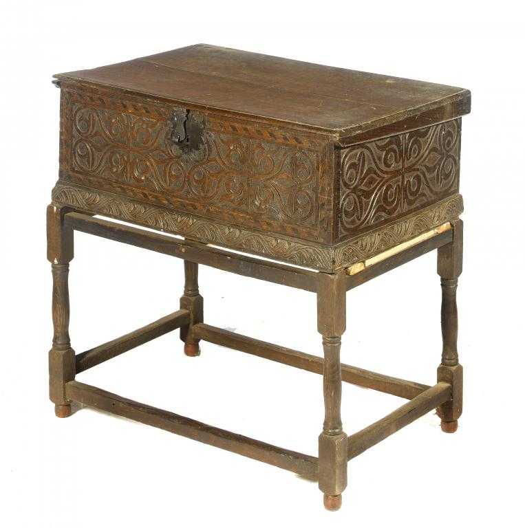 Appraisal: A CHARLES II BOARDED OAK BOX the sides carved with