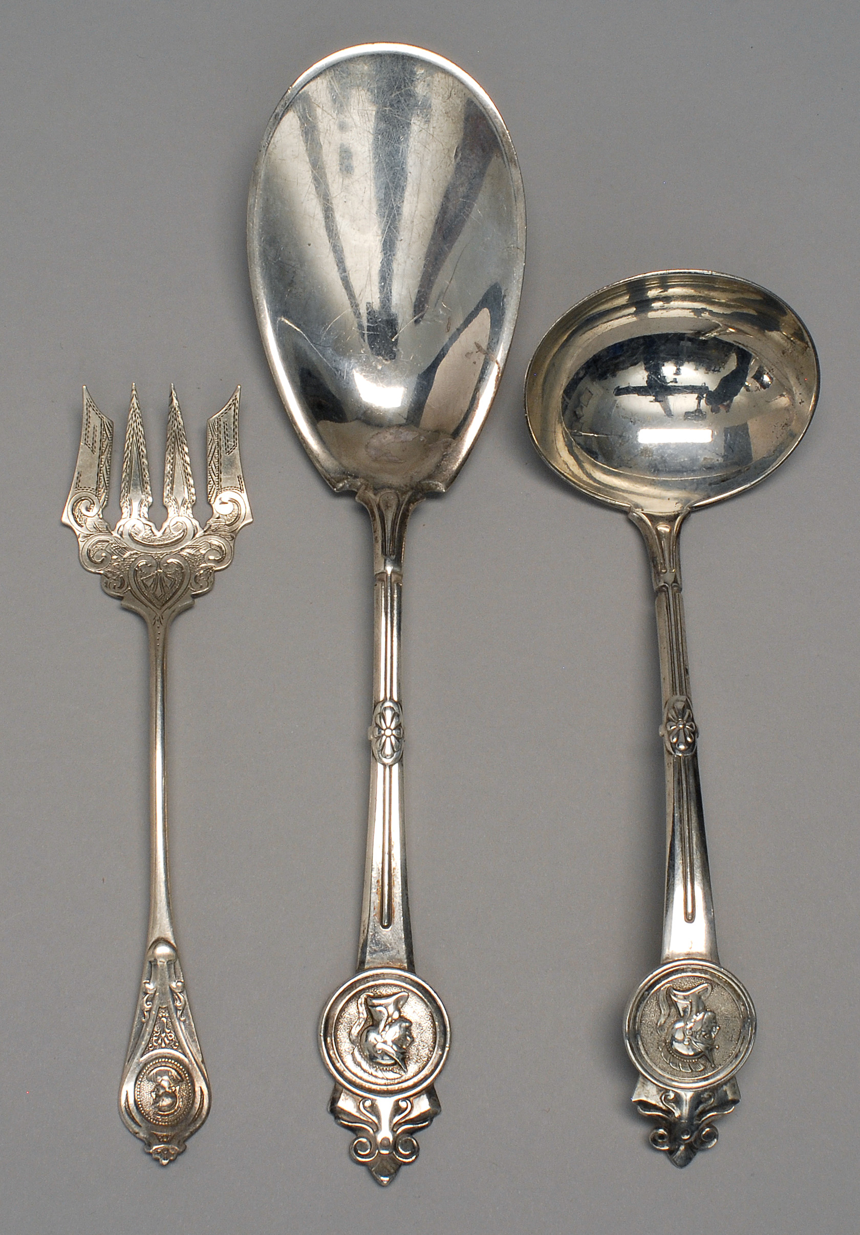 Appraisal: THREE PIECES OF AMERICAN MEDALLION PATTERN SILVER FLATWARE Two Gorham