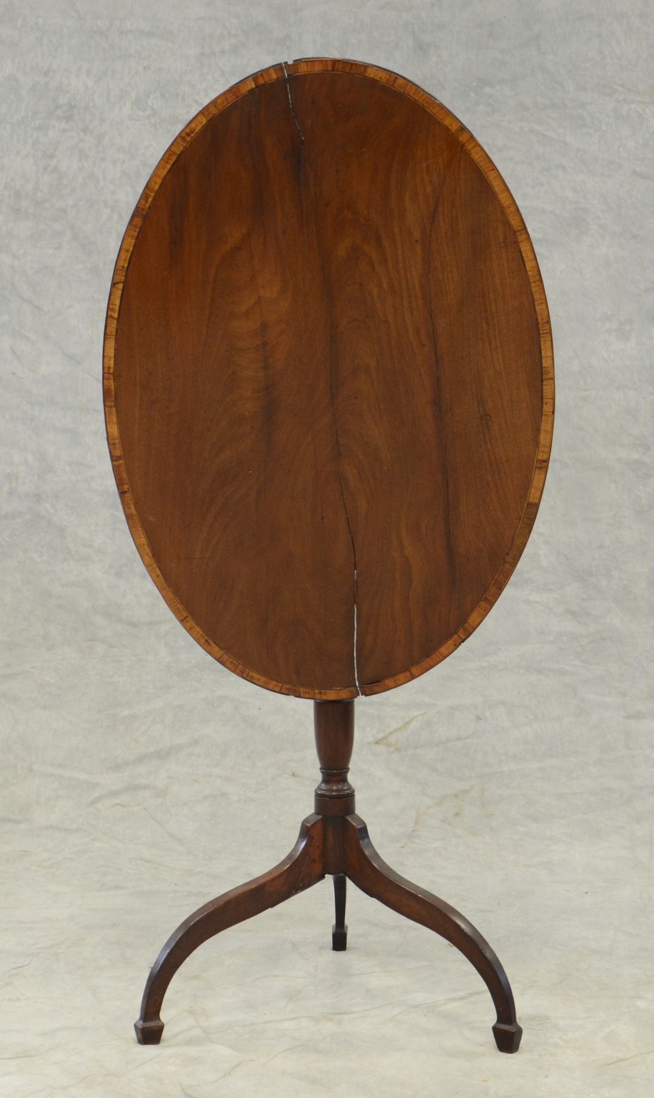 Appraisal: Mahogany oval tilt top candlestand with banded top slender pedestal