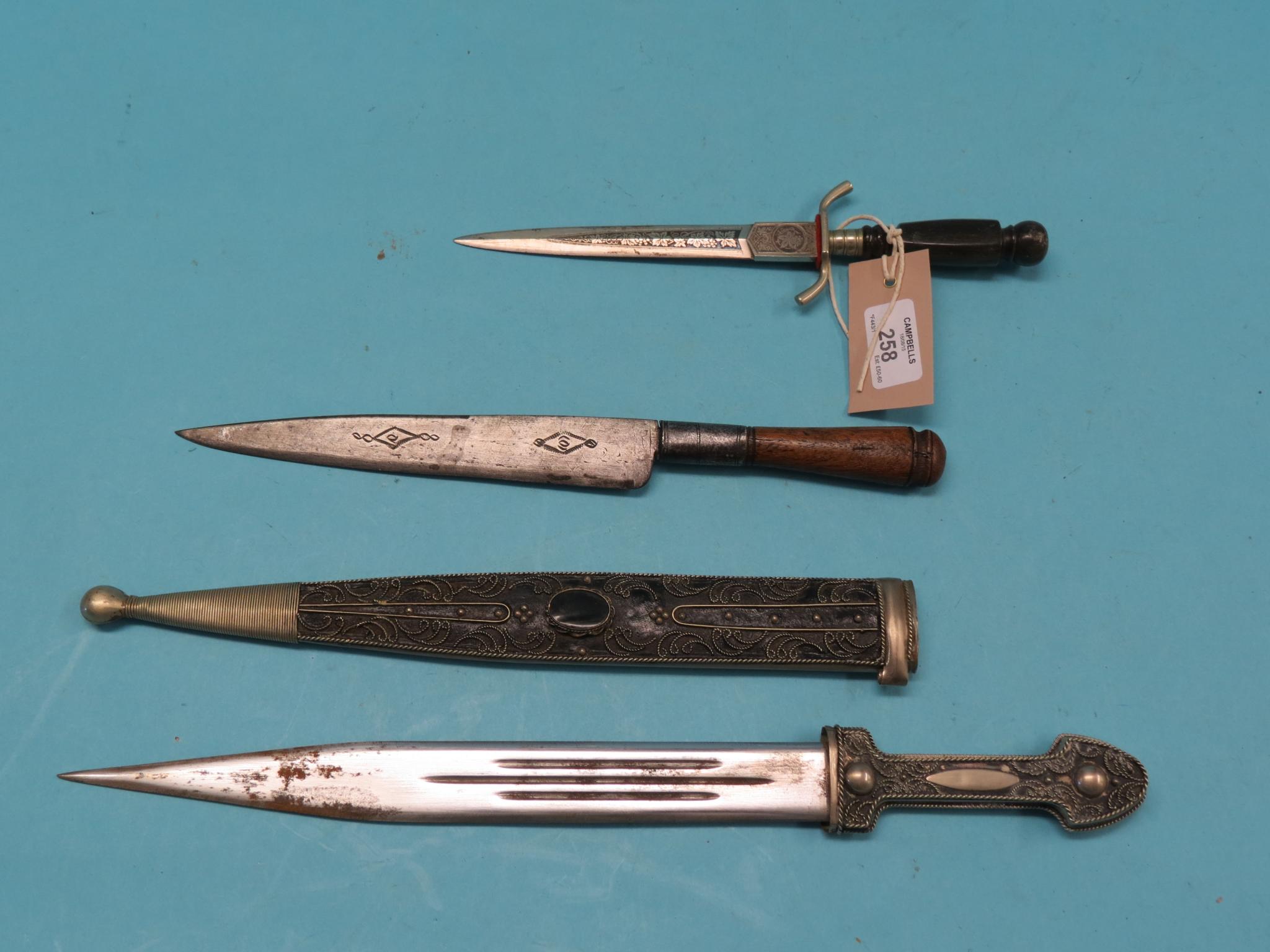 Appraisal: A metal filigree dagger in straight double-edged blade and two