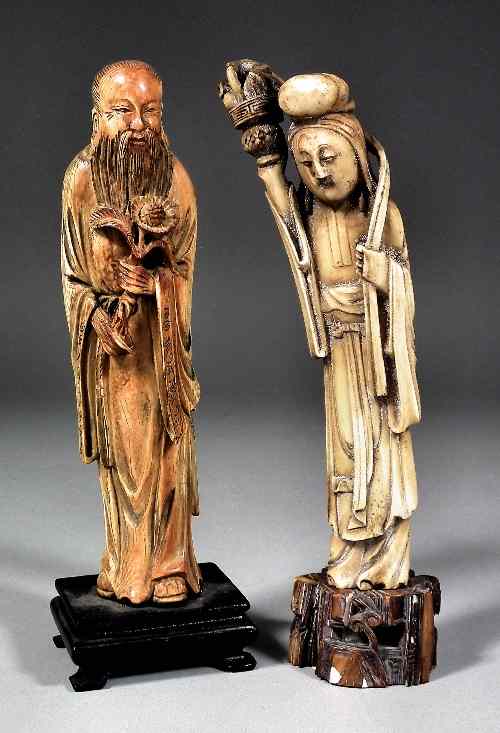 Appraisal: A Chinese carved ivory figure of a Scholar holding a