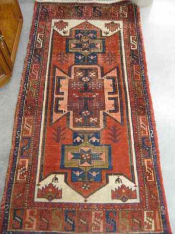 Appraisal: Heriz Persian Handmade Rug primarily reds blues and ivory geometrics