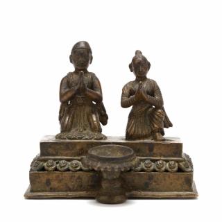 Appraisal: Nepalese Ritual Lamp with Couple Praying th- th century bronze