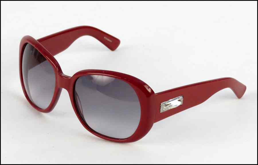 Appraisal: PAIR OF YVES SAINT LAURENT RED SUNGLASSES With rhinestone detail