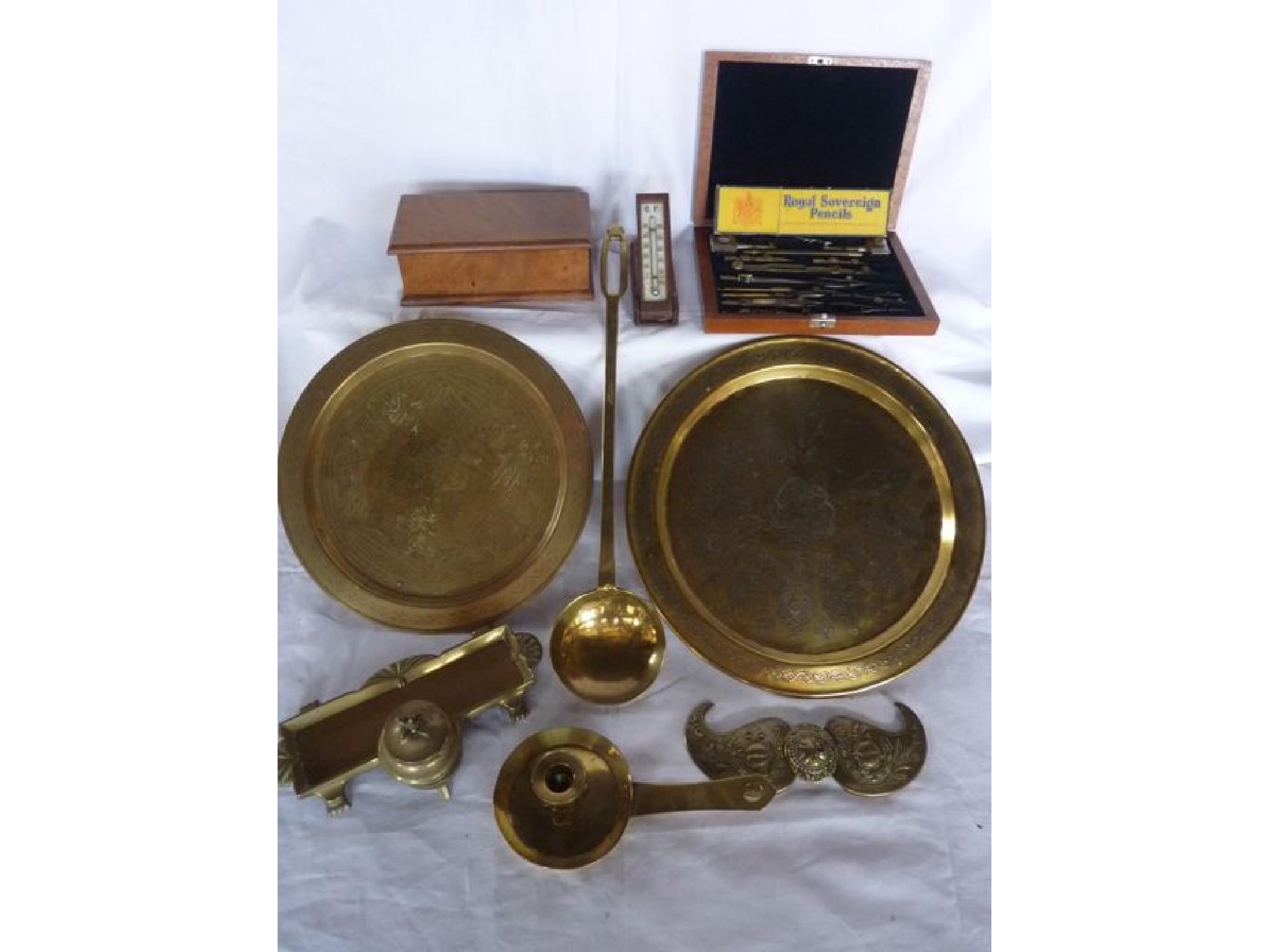 Appraisal: An Eastern brass buckle further brass trays brass chamber stick