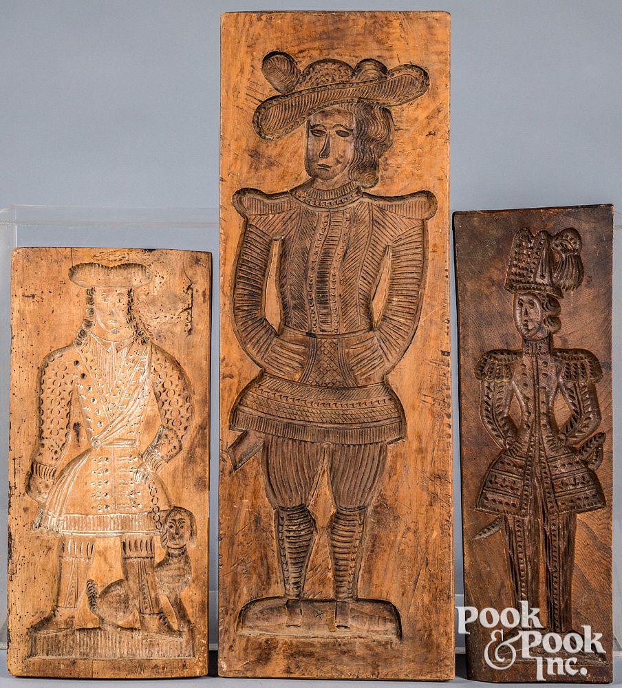 Appraisal: Three Dutch carved cakeboards th c with figur Three Dutch