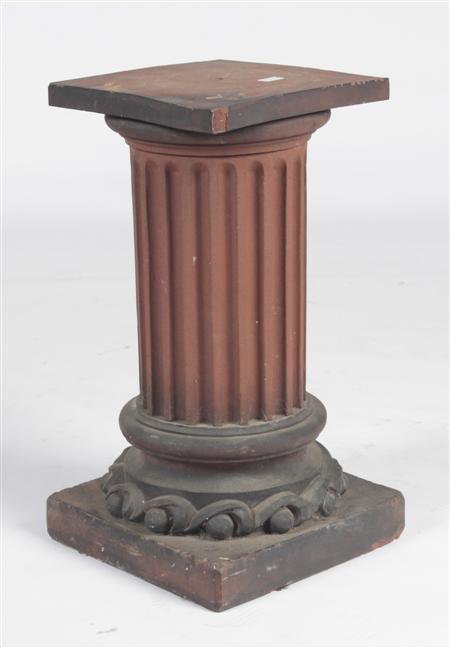 Appraisal: A terracotta pedestal the square top raised on a fluted