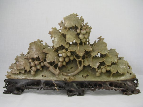 Appraisal: Twentieth century carved Chinese stone sculpture of grapes and leaves