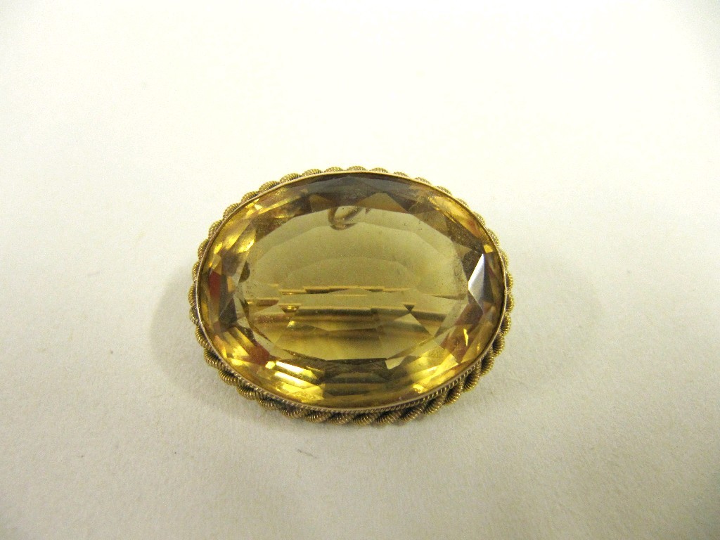 Appraisal: Oval cut citrine brooch in unmarked gold rope twist mount