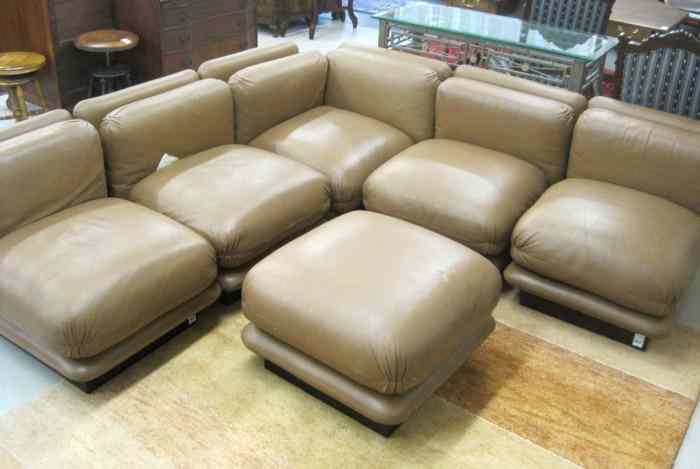 Appraisal: MODERN LEATHER MODULAR CORNER SOFA AND MATCHING OTTOMAN ''Cascade Modular