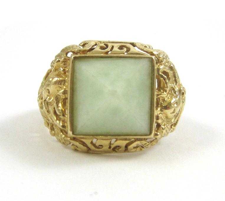 Appraisal: JADE AND FOURTEEN KARAT GOLD RING bezel set with a