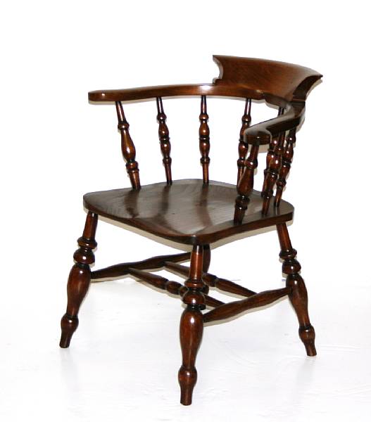 Appraisal: A Victorian elm and walnut captain's chair height in width