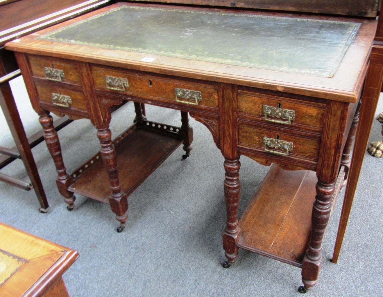 Appraisal: A late Victorian oak desk with leather inset top above