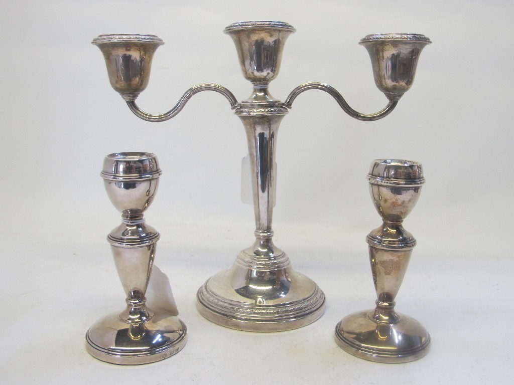 Appraisal: A lot comprising a silver three-branch candelabrum and a pair