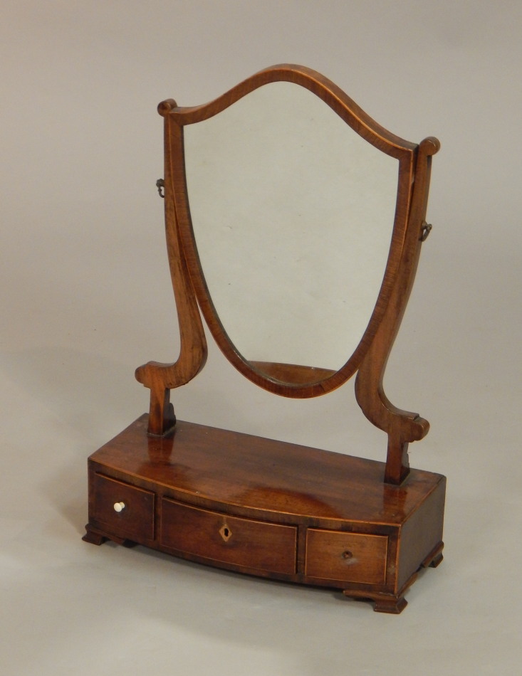 Appraisal: A George III mahogany dressing table mirror the shield shape