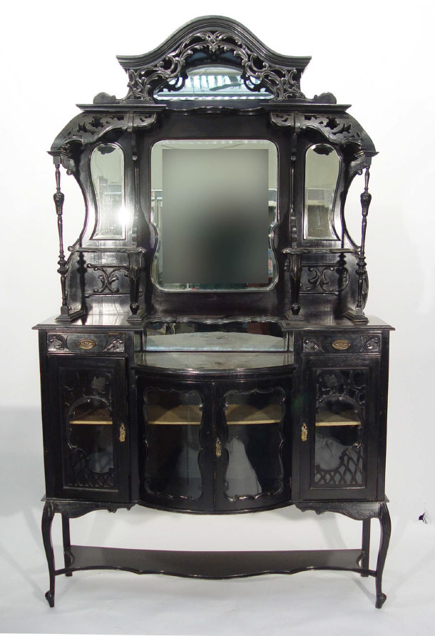 Appraisal: Victorian ebonised mirrored back cabinet with heavily carved mouldings above